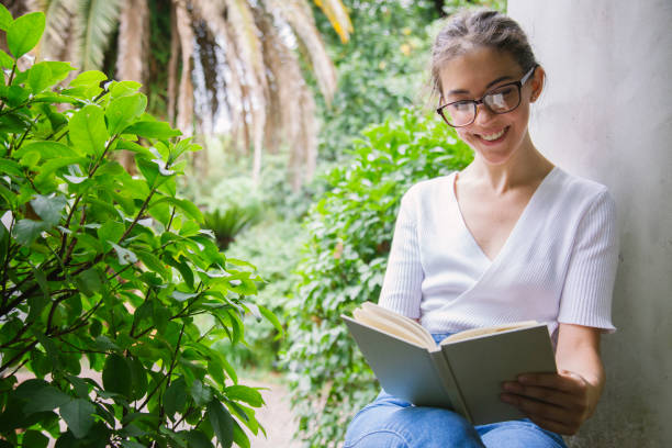 istock calm scene of a woman reading a book 1220344912
