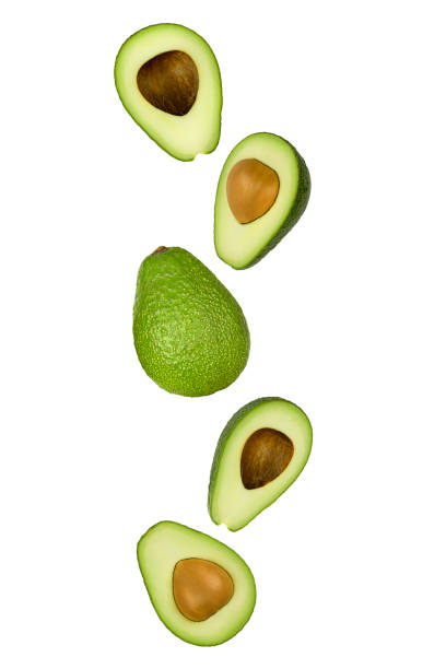 istock Falling green avocado isolated on white background with clipping path as package design element and advertising. 1220345063