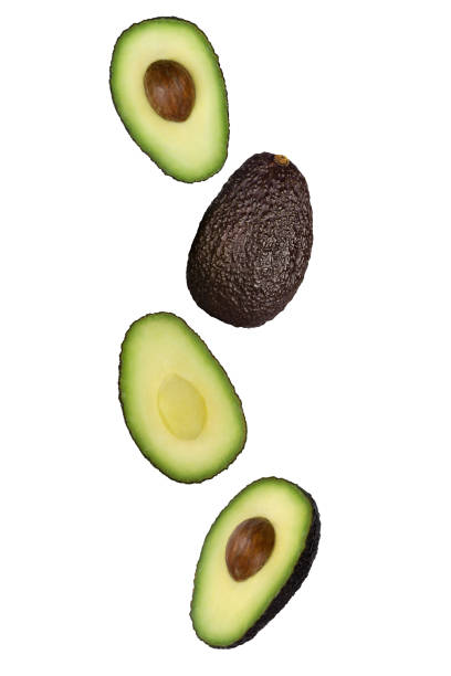 istock Falling brown avocado isolated on white background with clipping path as package design element and advertising. 1220345068