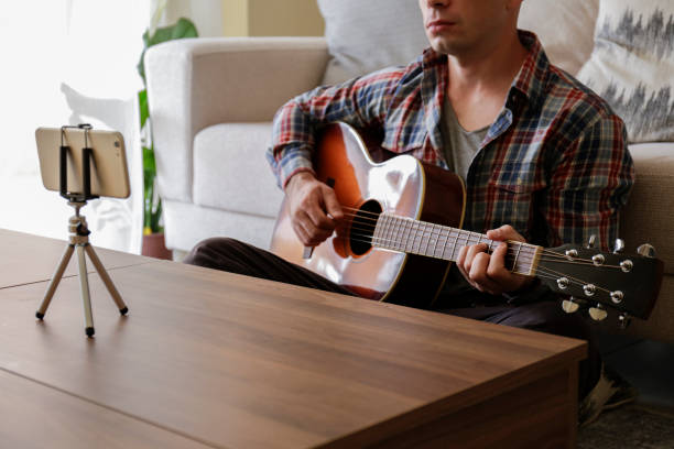 online school of music concept. man learning to lay am acoustic guitar at home. - fingerstyle imagens e fotografias de stock