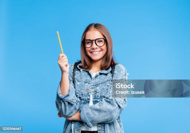 Portrait Of Petty Teenage Girl Poinitng With Pencile Stock Photo - Download Image Now