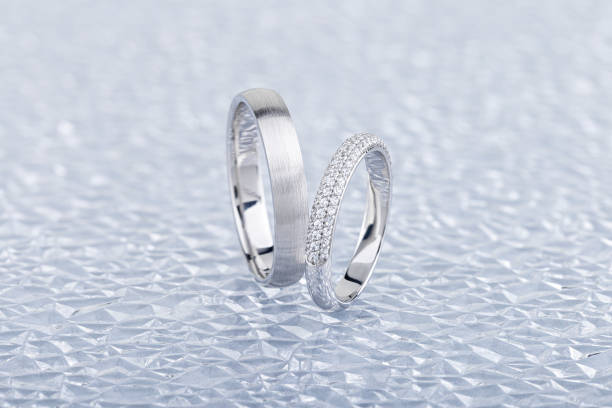 istock Pair of silver wedding rings on gray background 1220348204