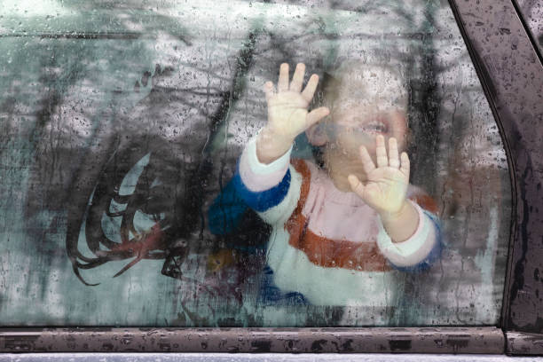 istock Toddler Behind the Window Looking Up 1220350152