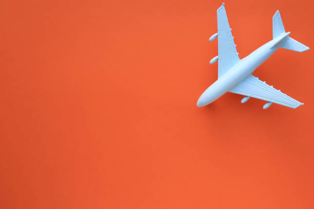 istock Model airplane on a orange background. Space for text. Travel concept. 1220350462