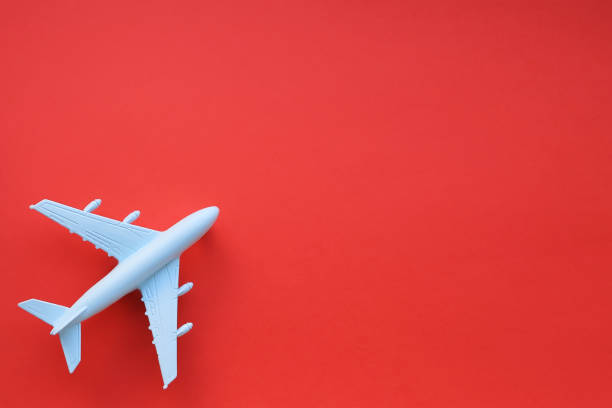 istock Model airplane on a red background. Space for text. Travel concept. 1220350537