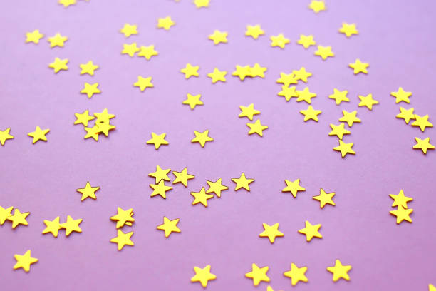 istock Golden stars glitter on pink background. 1220350589