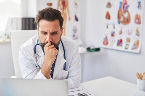 istock Busy doctor working with laptop in doctor’s office 1220350662