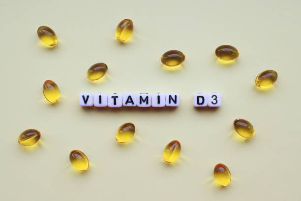 istock Vitamin D3 gel capsules on light background. 1220350699