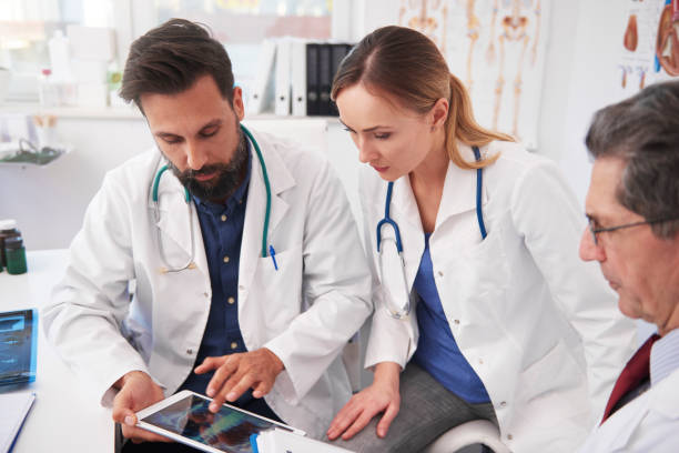 istock Three doctor working with tablet in doctor’s office 1220351055