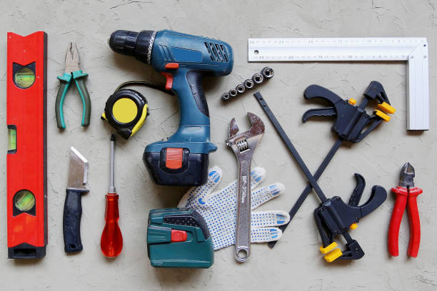 istock Construction worker tools on concrete background top view. Remodel and repair concept. 1220351177