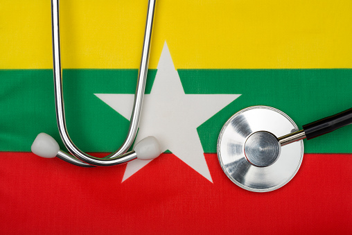 Myanmar flag and stethoscope. The concept of medicine. Stethoscope on the flag in the background.