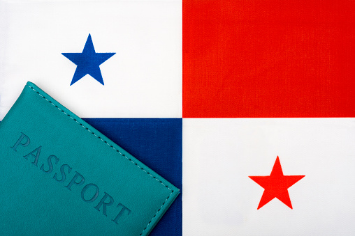 On the background of the flag of Panama is a passport. The concept of travel and tourism.