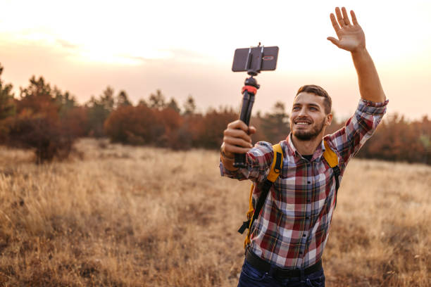 istock Man vlogging and having fun in nature 1220352546