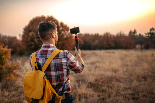istock Man vlogging and having fun in nature 1220352675