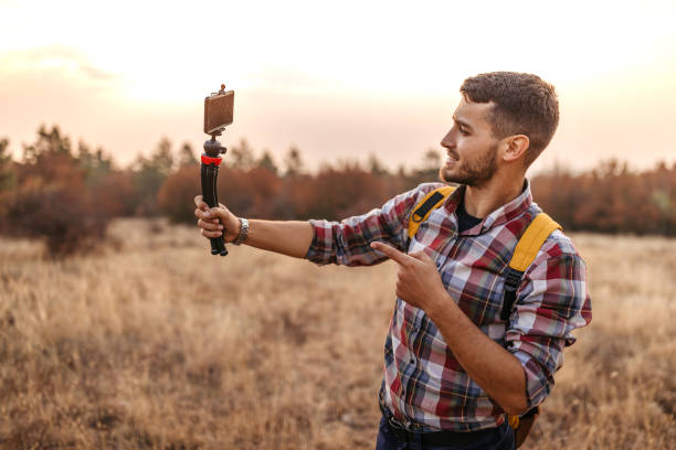 istock Man vlogging and having fun in nature 1220352912