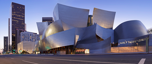 Los Angeles, California, USA - March 18, 2020: Night time panoramic view of the Disney concert hall located along Grand Avenue in downtown Los Angeles. Designed by Frank Gehry and opened in 2003, this is one of the four venues of the Los Angeles Music Center. It is home to the Los Angeles Philharmonic and the Los Angeles Master Chorale. Grand Avenue is home to many other cultural institutions such as the Broad museum as well as residential and office towers.