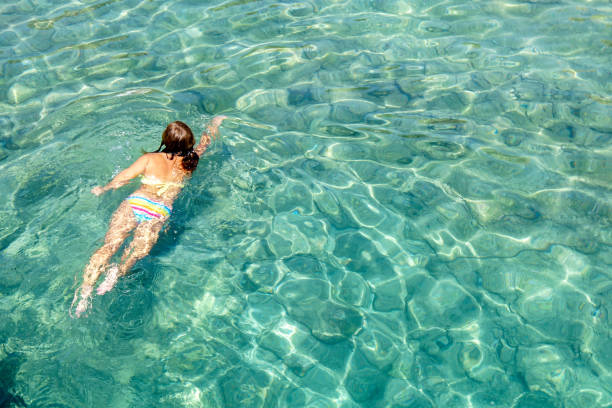 istock Woman floating in the clean sea. 1220357198