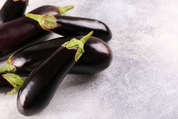 istock Uncooked vegetable washed clean. Top view of raw eggplant. 1220358433