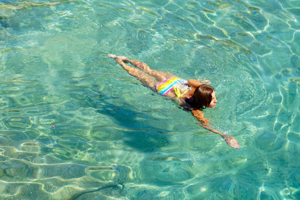 istock Woman floating in the clean sea. 1220358629