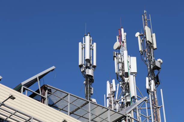 Mobile towers on blue sky background. Many communication equipment. Many mobile towers, satellites and repeaters on a background of blue sky. Wireless communication equipment. parabola stock pictures, royalty-free photos & images