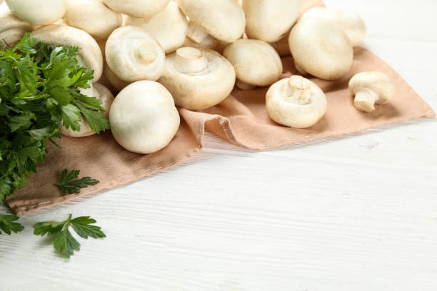 istock Uncooked mushrooms washed clean. Top view of raw champignons. 1220359862