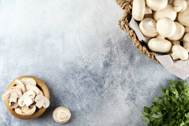 istock Uncooked mushrooms washed clean. Top view of raw champignons. 1220359899