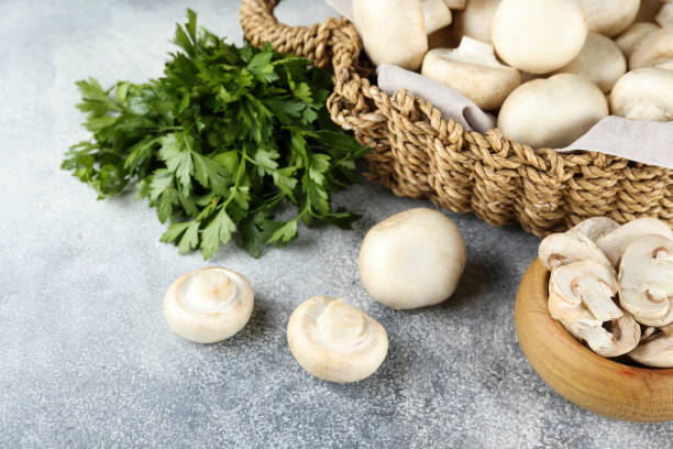 Uncooked mushrooms washed clean. Top view of raw champignons.