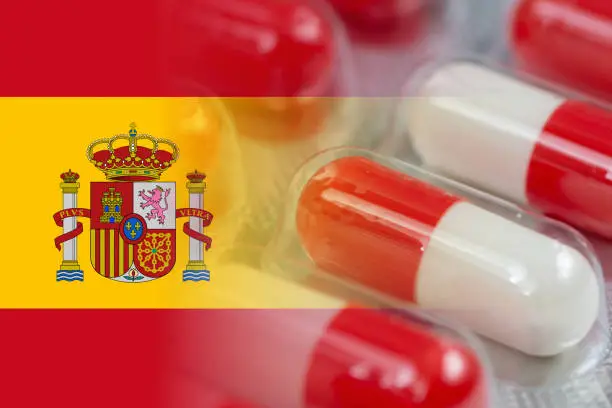 spanish flag mixed with antibiotics capsules in blister