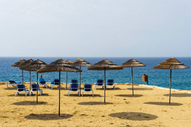 istock Beach sunbeds and parasols overlooking turquoise water 1220360277