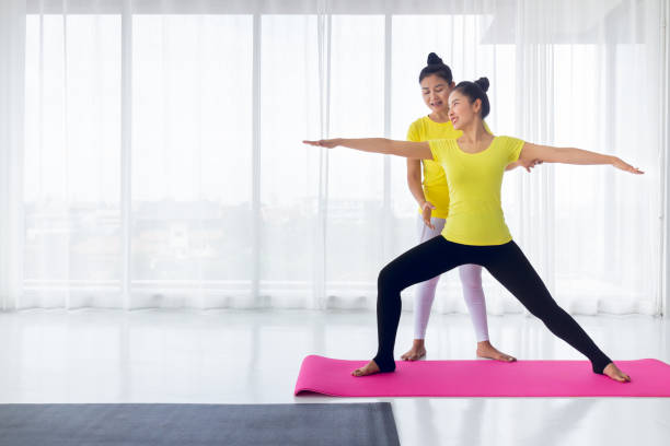 istock Yoga teachers are teaching exercise yoga for students. With the correct position Inside the room for good health and flexibility of the muscles with a feeling of happiness. It is a lifestyle activity healthy for everybody. 1220365133