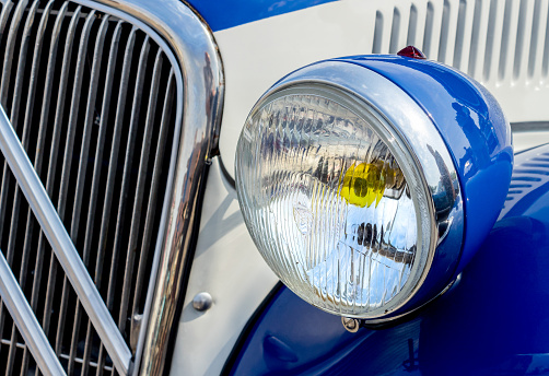 Headlight Detail of Blue Classic car