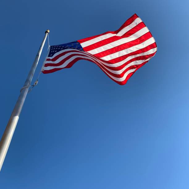 istock American Flag Flying on Windy Day 1220365899