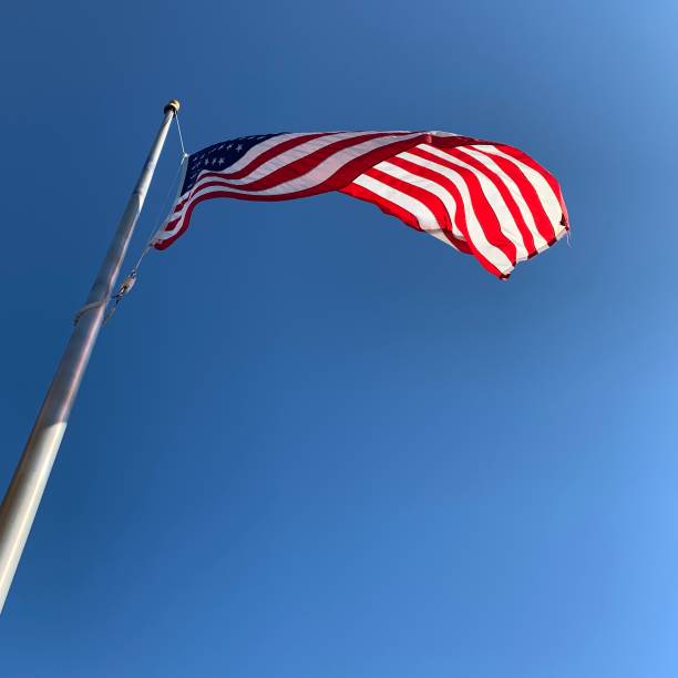 istock American Flag Flying on Windy Day 1220365930