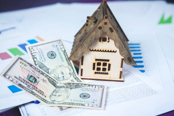 istock house model with money on graph 1220369682