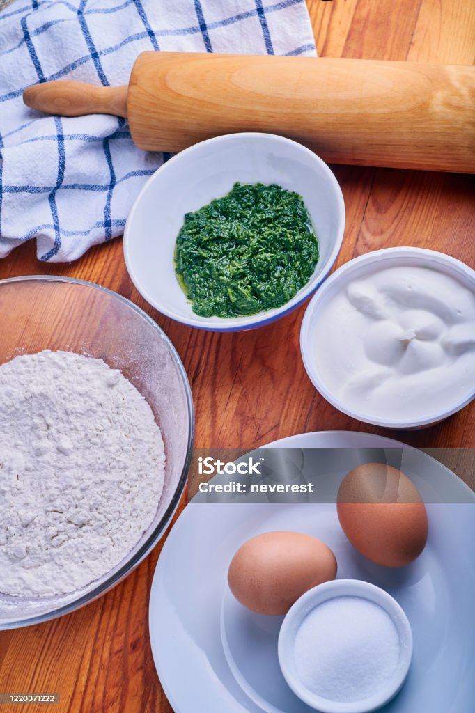Ravioli stuffed pasta ingredients Ingredients for making traditional italian stuffed pasta ravioli or tortilla with ricotta cheese and spinach Bakery Stock Photo