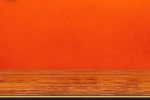 istock Wooden board empty table in front of blurred orange background 1220373704