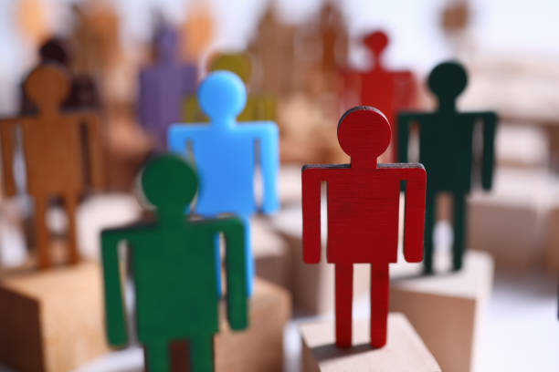 istock Wooden figures in form people on blocks leadership 1220373719