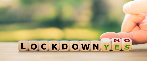istock End of the corona lockdown? Hand turns dice and changes the expression 