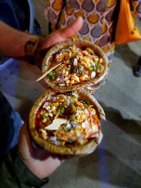 This is an image of a couple of plates of Samosa Chaat, an Indian street food snack on the streets of Varanasi, India.