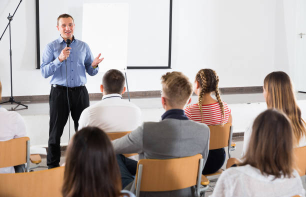 istock Male teacher lecturing to students 1220374389