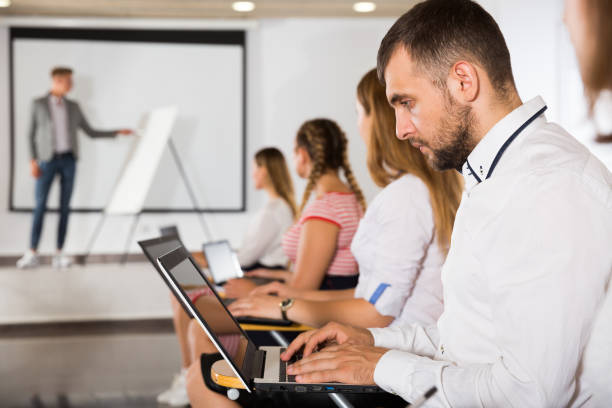 istock Side view of young people with laptops 1220374400