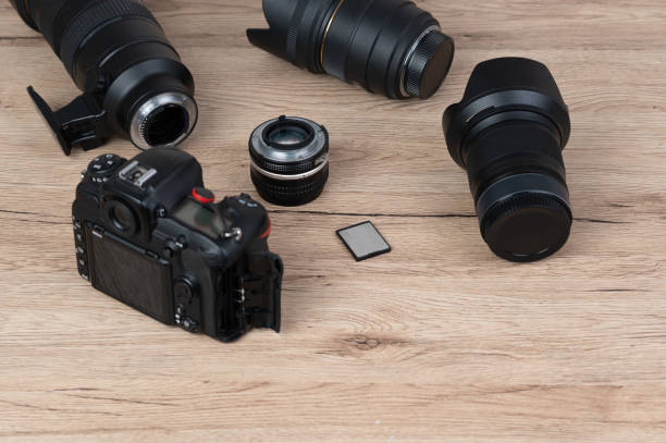 istock memory card, digital camera, dslr and body black camera placed on a wooden table 1220376017