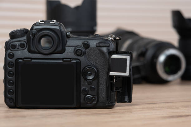 istock memory card, digital camera, dslr and body black camera placed on a wooden table 1220376020