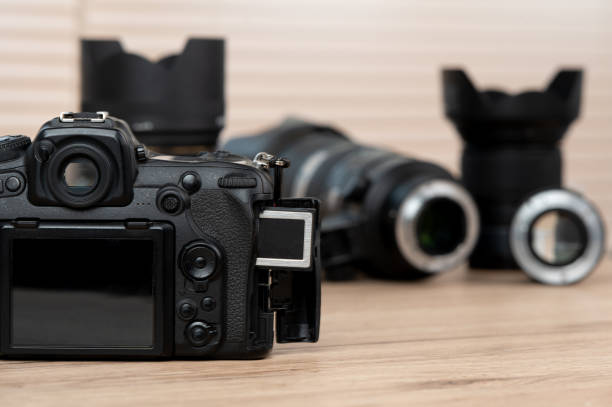 istock memory card, digital camera, dslr and body black camera placed on a wooden table 1220376066