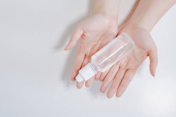 istock clean and protect COVID-19 virus activity from top view woman hand during use alcohol gel with white isolated background 1220376437