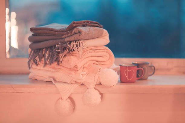 istock Mugs and cozy plaids on window in night 1220376756