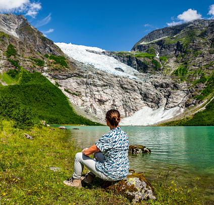 Woman at the Bøyabreeen glacier in Norway, Scandinavia