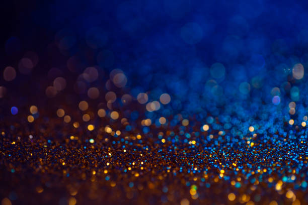 istock Decoration bokeh lights background, abstract sparkle backdrop with circles,modern design overlay with sparkling glimmers. Blue and golden backdrop glittering sparks with blur effect. 1220378303
