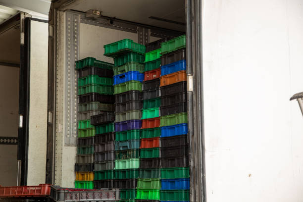istock Truck loading. Plastic boxes with ripe berries are loaded into the refrigerator. 1220378508