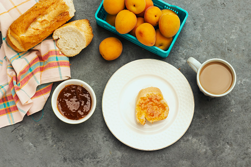 breakfast with apricot jam and slice of bread